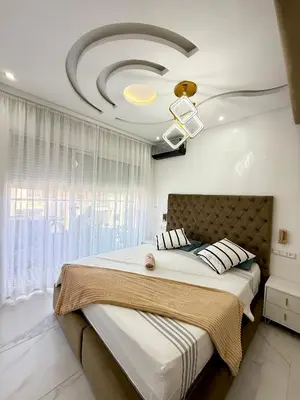 a bedroom with a large bed with a large window at KSYI IMMO 2 Marrakech Aéroport in Marrakech