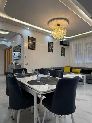 a dining room with a table and chairs at KSYI IMMO 2 Marrakech Aéroport in Marrakech