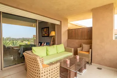 a living room with a couch and a table at Relax Front of Panoraview Pool golf Atlas in Marrakech