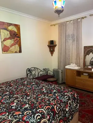 a bedroom with a bed and a painting on the wall at Raid Maison H in Marrakech