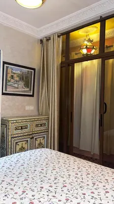 a bedroom with a bed and a dresser at Raid Maison H in Marrakech