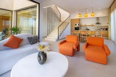 a living room with a couch and orange chairs at Villa Piscine Privée, Petit déjeuné et ménage inclus in Marrakech