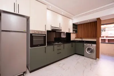 a kitchen with a refrigerator and a washing machine at Bright Flat in Heart of Center in Marrakech
