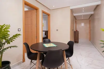 a meeting room with a table and chairs at Bright Flat in Heart of Center in Marrakech