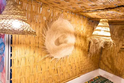 a wicker wall with two lights and two chandeliers at Riad Sala Art Marrakech in Marrakech