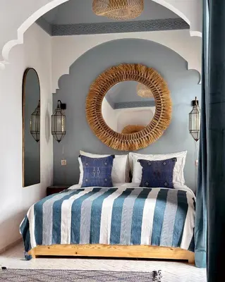 a bedroom with a bed with a large mirror at Riad Jalma in Marrakech
