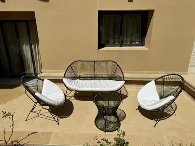 a group of three chairs and a table with a bench at Dream Land Duplex for families in Marrakech