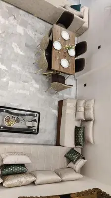 a living room with a couch with pillows on a wall at Dream Land Duplex for families in Marrakech