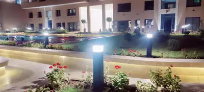 a building with a courtyard with flowers and lights at Dream Land Duplex for families in Marrakech