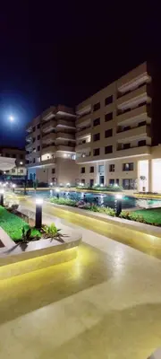 a blurry picture of a city at night with buildings at Dream Land Duplex for families in Marrakech
