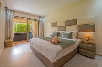 a large bedroom with a large bed and a balcony at Luxury XL Appart Golf View Retreat Private Garden in Marrakech
