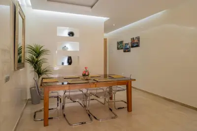 a dining room with a wooden table and chairs at Luxury XL Appart Golf View Retreat Private Garden in Marrakech