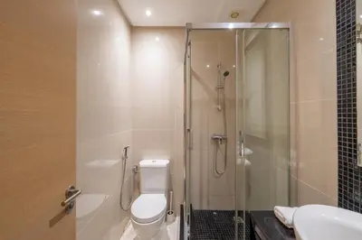 a bathroom with a shower and a toilet and a sink at Luxury XL Appart Golf View Retreat Private Garden in Marrakech