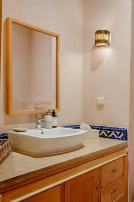 a bathroom with a white sink and a mirror at Villa Atlas Harmony Marrakech in Marrakech
