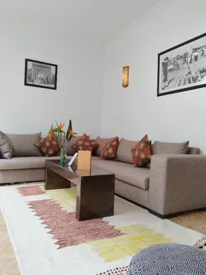 a living room with a couch and a coffee table at Riad L'Arganier in Marrakech