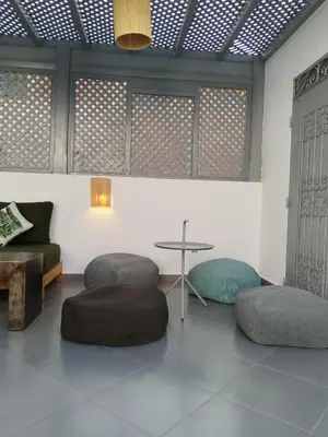 a room with a table and some chairs at Riad L'Arganier in Marrakech