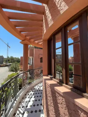 a balcony with awning and windows on a building at Dar Bensoussen in Marrakech