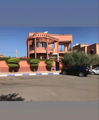 a building with a car parked in front of it at Dar Bensoussen in Marrakech