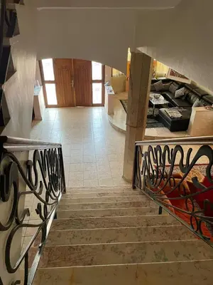 a staircase leading to a living room with a couch at Dar Bensoussen in Marrakech