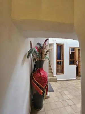 a hallway with a large vase with a plant in it at Riad Córdoba in Marrakech