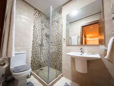 a bathroom with a toilet and a sink and a shower at Appartement de Luxe bien équipé in Marrakech