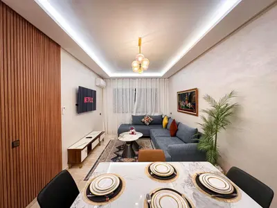 a living room with a couch and a table at Appartement de Luxe bien équipé in Marrakech