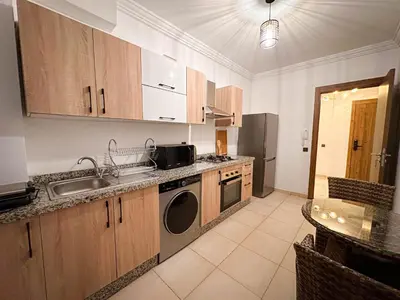 a kitchen with a sink and a dishwasher at Appartement de Luxe bien équipé in Marrakech