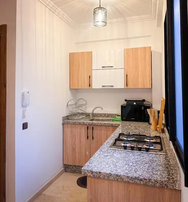 a kitchen with a stove and a counter top at Prestigieux Appartement in Marrakech