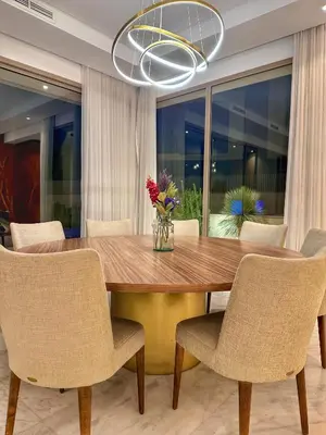 a dining room with a wooden table and chairs at villa argan golf piscine chauffée in Marrakech