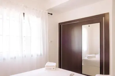a bathroom with a mirror and a sink and a window at Designer Gueliz Penthouse - Terrace - Atlas Views in Marrakech