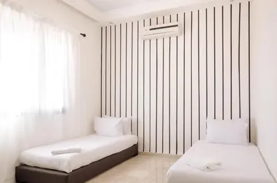 two beds in a room with white walls at Designer Gueliz Penthouse - Terrace - Atlas Views in Marrakech