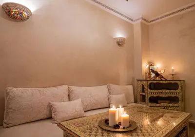 a living room with a couch with candles on a table at Authentic house in the old Medina of Marrakech in Marrakech