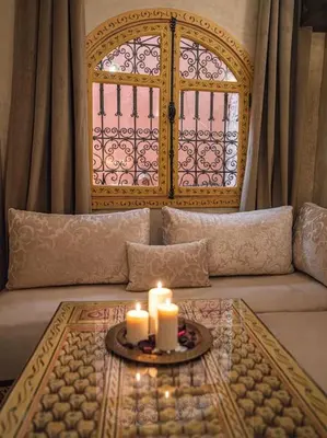 a living room with a couch with candles on a table at Authentic house in the old Medina of Marrakech in Marrakech
