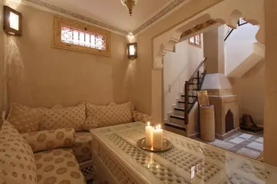 a living room with a couch with a candle on a table at Authentic house in the old Medina of Marrakech in Marrakech