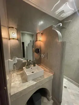 a bathroom with a sink and a mirror at Riad Awatif le 36 in Marrakech