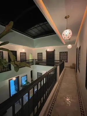 a hallway in a house with a ceiling and a chandelier at Riad Awatif le 36 in Marrakech
