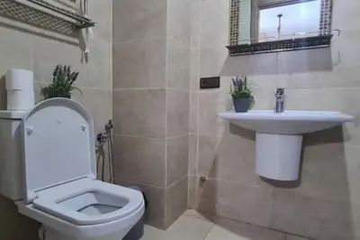 a bathroom with a toilet and a sink at appartement de luxe gueliz in Marrakech