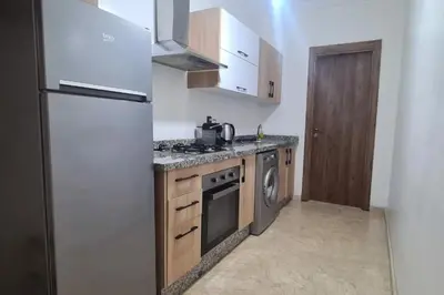 a kitchen with a refrigerator and a stove top oven at appartement de luxe gueliz in Marrakech