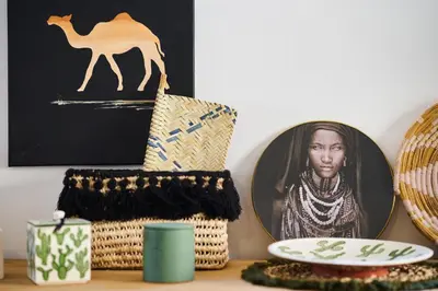 a table with a picture of a woman and a camel at Riad Kbala in Marrakech