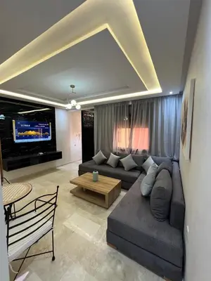a living room with a couch and a table at Gueliz Luxe Apartment in Marrakech