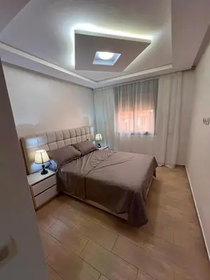 a bedroom with a large bed and a window at Gueliz Luxe Apartment in Marrakech