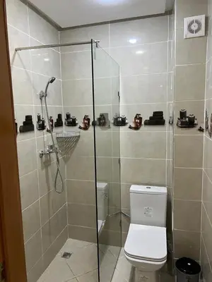 a bathroom with a shower and a toilet at Gueliz Luxe Apartment in Marrakech