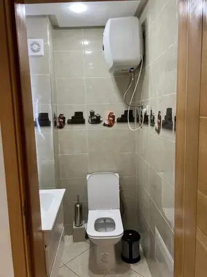 a small bathroom with a toilet and a sink at Gueliz Luxe Apartment in Marrakech