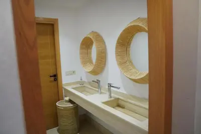 a bathroom with two sinks and two mirrors at Villa Home Orient Avec Piscine Privée 3 Chambres in Marrakech