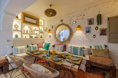 a living room with a table and a couch at Riad Chill&Relax Dar Tayri in Marrakech