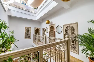 an ornate staircase in a home with white walls and ceilings at Riad Chill&Relax Dar Tayri in Marrakech