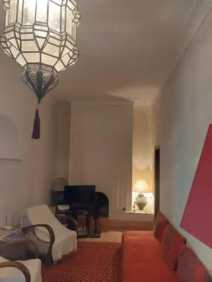 a living room with a couch and a chandelier at Riad Dar Lalla Fatna in Marrakech