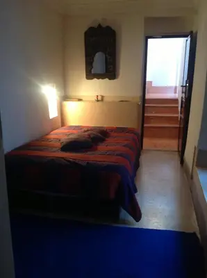a bedroom with a bed in a room with a doorway at Riad Dar Lalla Fatna in Marrakech