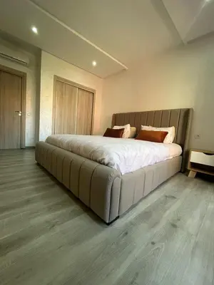 a bedroom with a large bed in a room at Appartement avec piscine in Marrakech