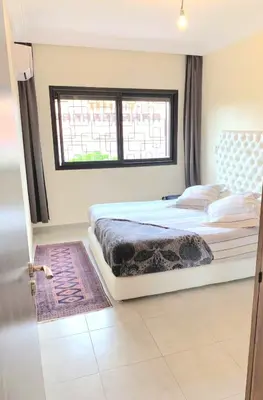 a bedroom with a bed and a window at Appartement Marrakech Guéliz in Marrakech